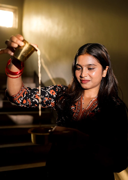 Woman pouring South Indian coffee with elegance