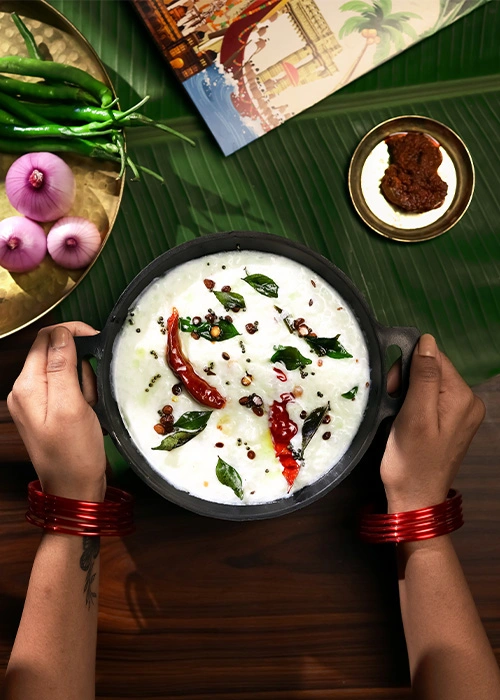 South Indian food served on a banana leaf with curd and onion
