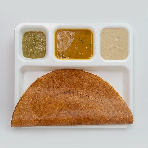 Crispy dosa served with chutney and sambar