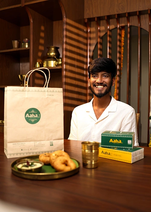 Customer receiving food delivery from Aaha Truly South restaurant