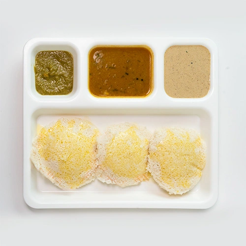 Soft ghee idly served with chutney and sambar