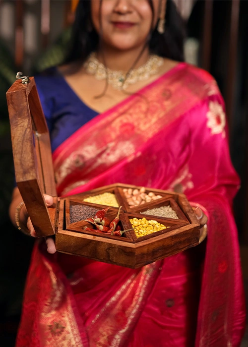 Person carrying a traditional South Indian meal in a lunch box