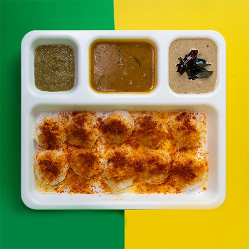 Mini ghee podi idly served with chutney and sambar