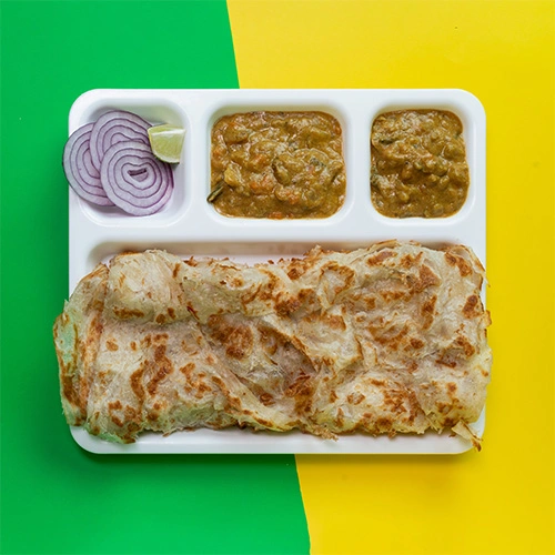 Flaky and soft parotta served with curry