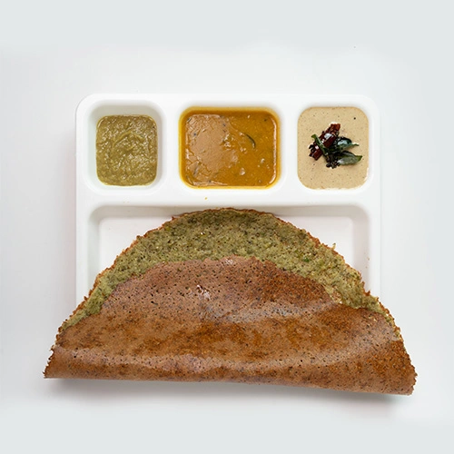 Delicious South Indian pesarattu made with green gram, served with chutney and sambar