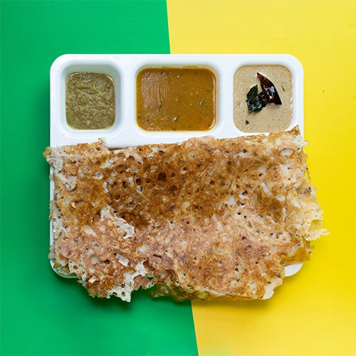 Crispy rawa dosa served with chutney and sambar