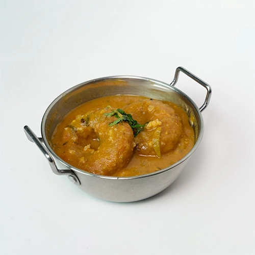 Crispy South Indian vada soaked in sambar