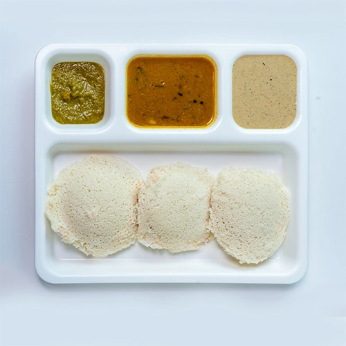 Traditional South Indian idli served with sambar and chutney